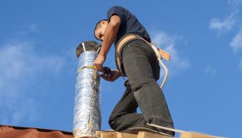 installer wraps the air duct with mineral wool and foil